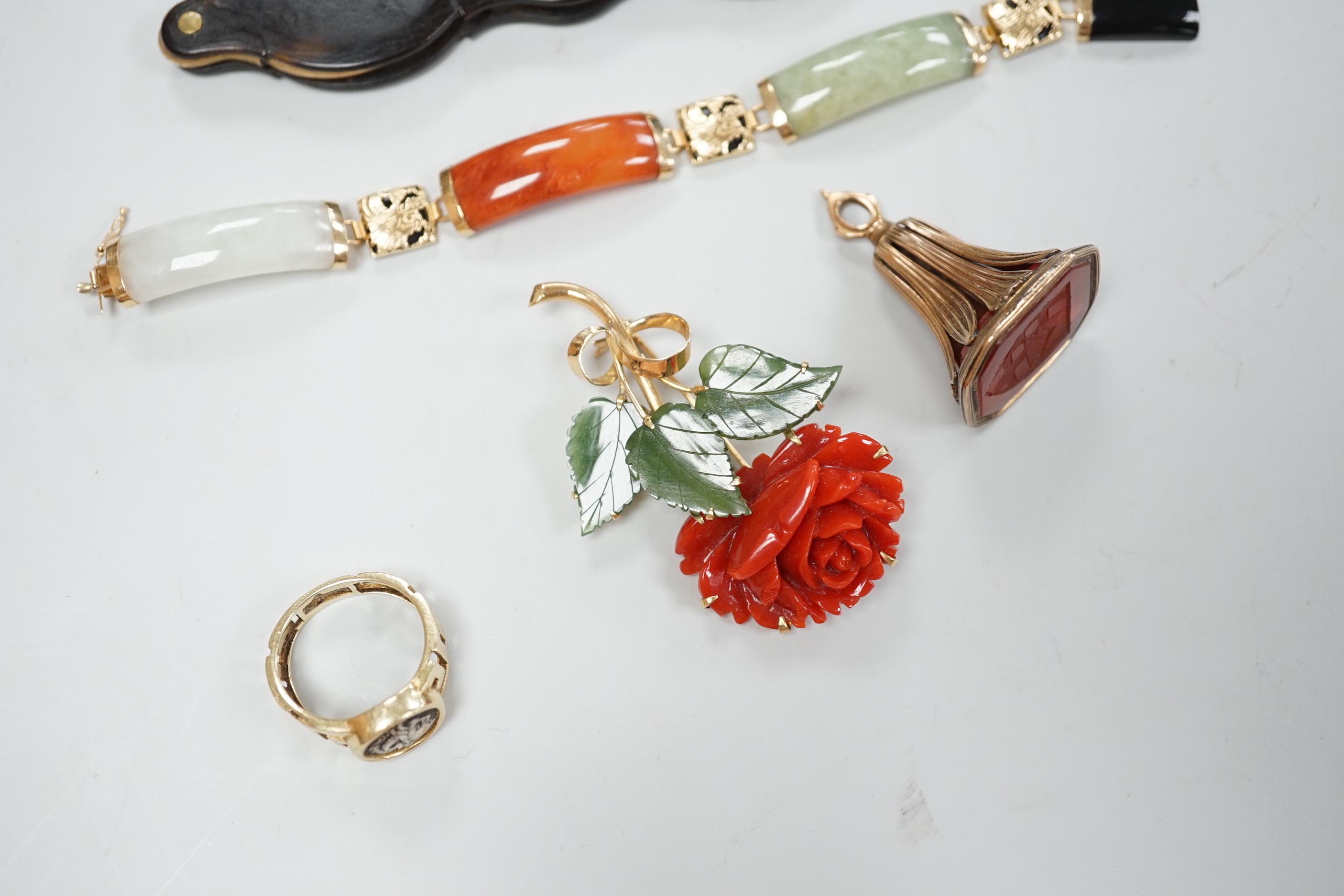 A 19th century yellow metal overlaid and carnelian set fob seal, 39mm, a 585 ring with bust, a pair of tortoiseshell mounted lorgnettes, an 18k coral and green hardstone set rose brooch and a yellow metal and hardstone b